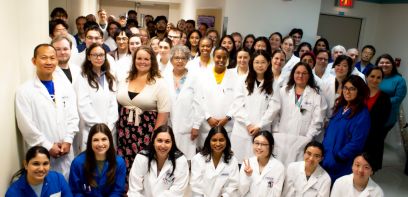 group of 50 researchers in lab coats